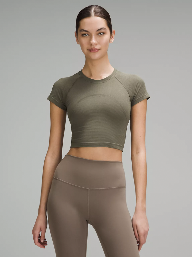 Swiftly Tech Cropped Short-Sleeve Shirt 2.0 in muted olive on model on dark gray background