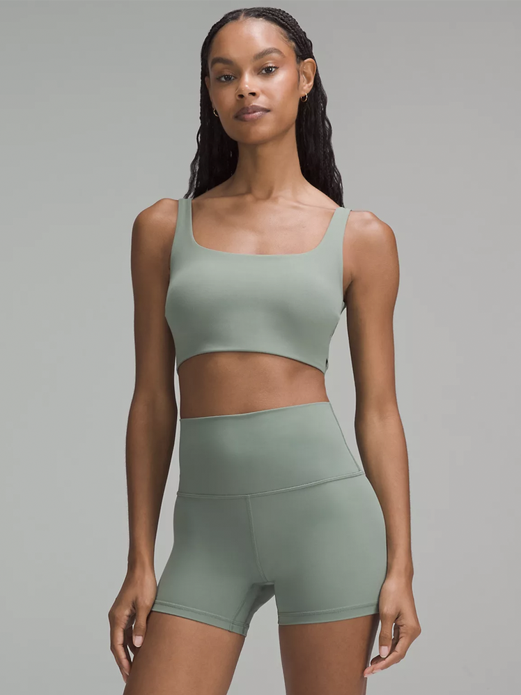 Bend This Scoop and Square Bra in muted green color way on model on dark gray background