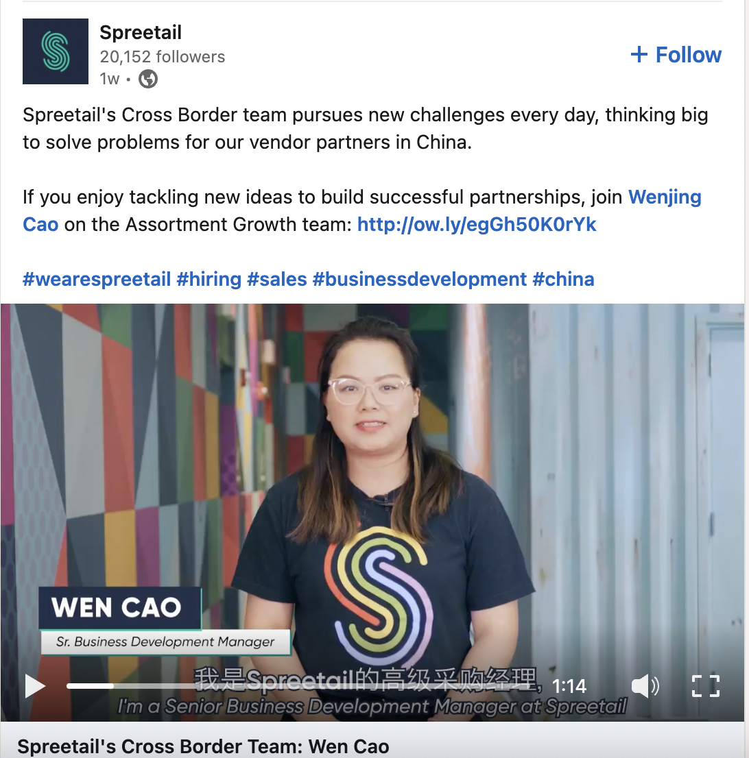 A screenshot of a LinkedIn video from Spreetail. In the post, they share the benefits of working on their team and how people can apply to an open role. In the video still, a current team member wears a Spreetail tshirt and is sitting against a colorful backdrop. In the video, she shares more about her experience working for the company.