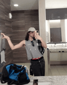 a man taking a selfie in a public restroom