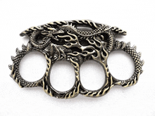 a brass knuckle duster with a dragon on it