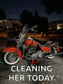 a red harley davidson motorcycle is parked in a driveway