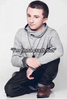 a young man kneeling down with the words " i 'm finna crash out " on the bottom right