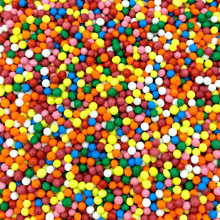 a close up of a pile of colorful sprinkles on a table