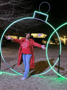 a woman wearing a red coat and a shirt that says i came sleigh