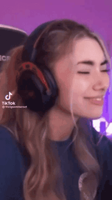 a woman wearing headphones has a tiktok icon on her face