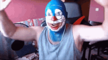 a man wearing a blue mask with a cat face on it