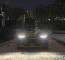 a woman is sitting on the hood of a yellow car with a license plate that says ' sd ' on it