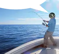 a man on a boat is fishing with a helmet on his head