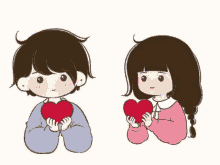 a boy and a girl are holding a red heart