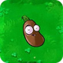 a cartoon bean with big eyes is sitting on a green field .