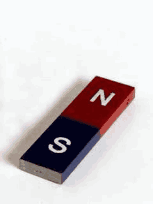 a red and blue magnet with the letters n and s on it is on a white surface .