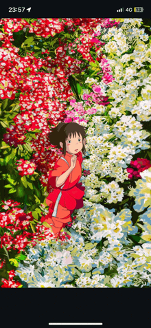 a girl in a red dress is surrounded by flowers on a phone screen