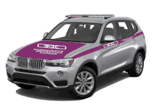 a silver bmw suv with a purple stripe that says fcc