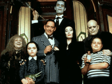 the cast of the addams family pose for a photo