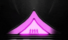 a group of people are standing on a stage in front of a purple triangle .