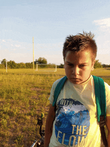 a young boy wearing a t-shirt that says with the flow