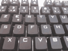 a close up of a keyboard showing the letters x c and v