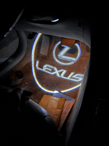 a lexus logo is projected onto the floor of the car