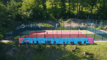 an aerial view of a tennis court with the letters s i c f l o z t written on the fence