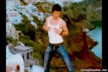 a man in a white tank top and jeans is dancing in front of a landscape with the words freegifmaker.me below him