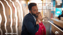 a man in a suit is hugging a little girl in a pink jacket with the hashtag #zoeysplaylist