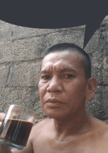 a shirtless man is holding a cup of coffee