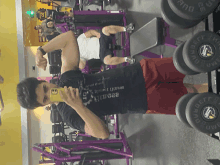 a man taking a picture of himself in a gym while wearing a shirt that says ' brazil ' on it