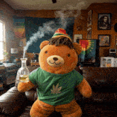 a teddy bear wearing a green shirt with a leaf on it