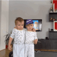 a boy wearing a milka hat stands with another boy