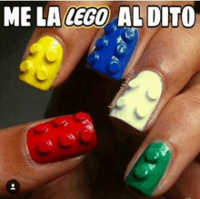 a woman 's nails are painted in different colors to look like lego blocks .