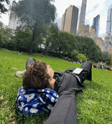 a person laying on the grass with a blue bag that says a on it