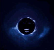 a black hole with a smiley face on it in the middle of space .