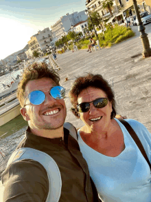 a man wearing sunglasses and a woman wearing sunglasses pose for a picture