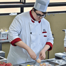 a man in a chef 's uniform with a chinese symbol on his chest