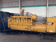 a cat engine is wrapped in plastic and sitting in a warehouse