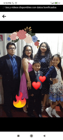 a group of people posing for a picture with hearts on their hands