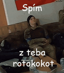 a man in a military uniform is sitting on a couch with the words spin z teba rotokokot written above him