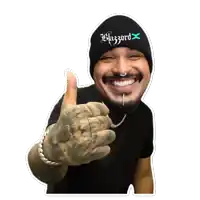 a man wearing a black beanie that says blizzard x gives a thumbs up