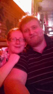 a man and a woman are posing for a picture in a restaurant