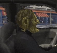 a man in a mask is sitting in a car