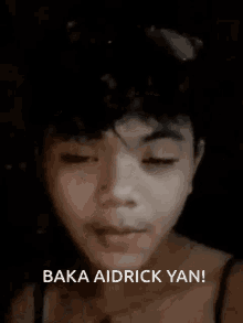 a close up of a young man 's face with the words baka aidrick yan written below him