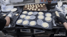 a tray of dough sits on top of another tray of dough with the words made in animotica below it