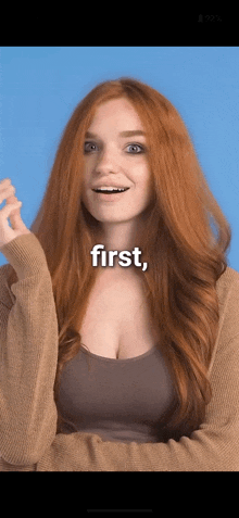 a woman with red hair is smiling with the word first above her