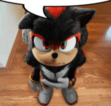 a stuffed shadow the hedgehog with a speech bubble behind him