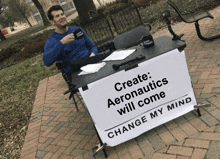 a man sits at a table that says create aeronautics will come