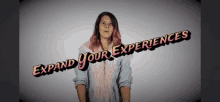 a woman with pink hair stands in front of a banner that says expand your experiences