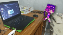 a laptop is open on a desk with a drawing of a girl in a cat outfit