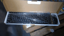 a keyboard and mouse in a cardboard box that says victory