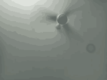 a white ceiling fan is spinning on a gray ceiling